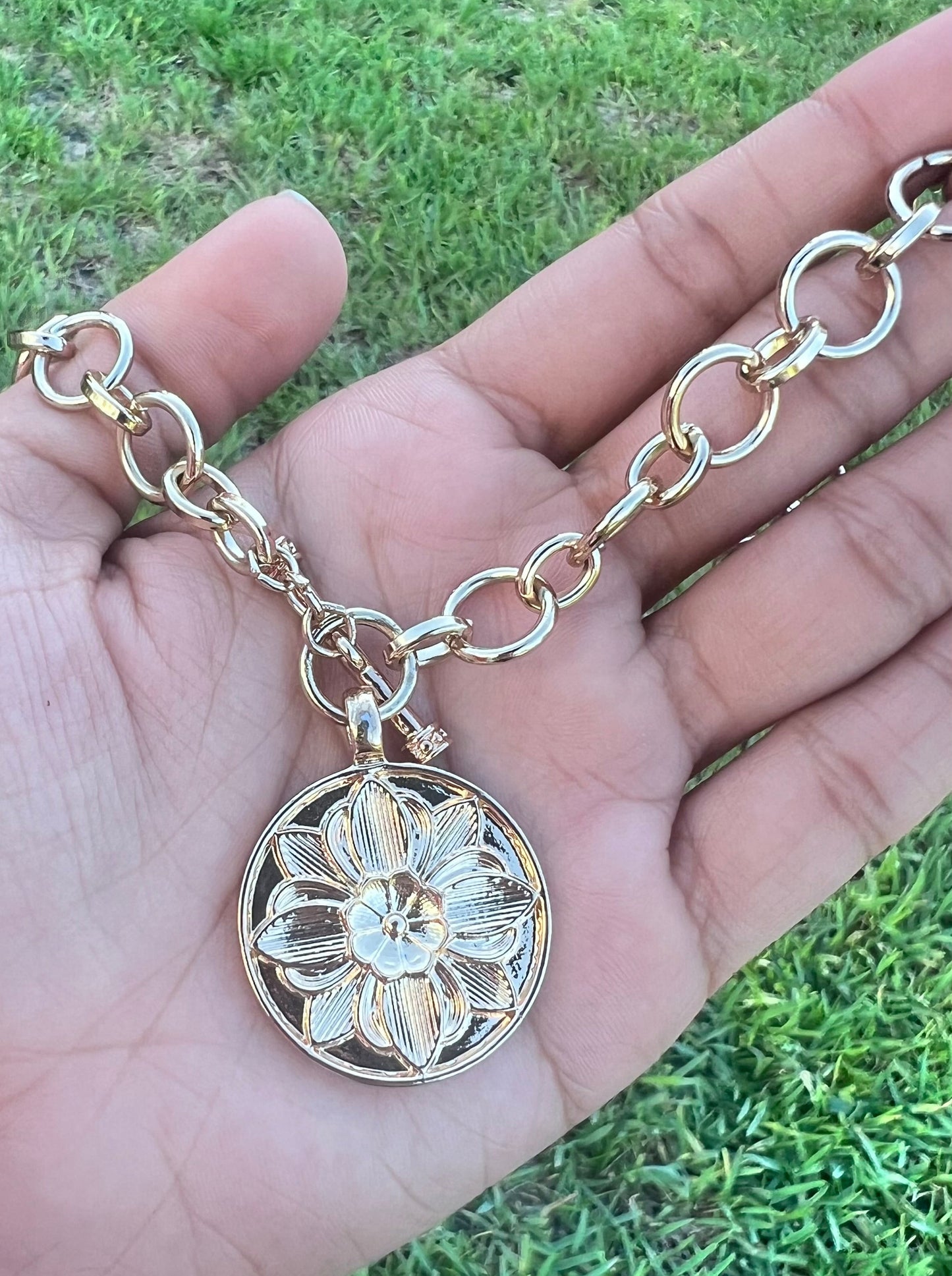 Gold chain with flower medallion