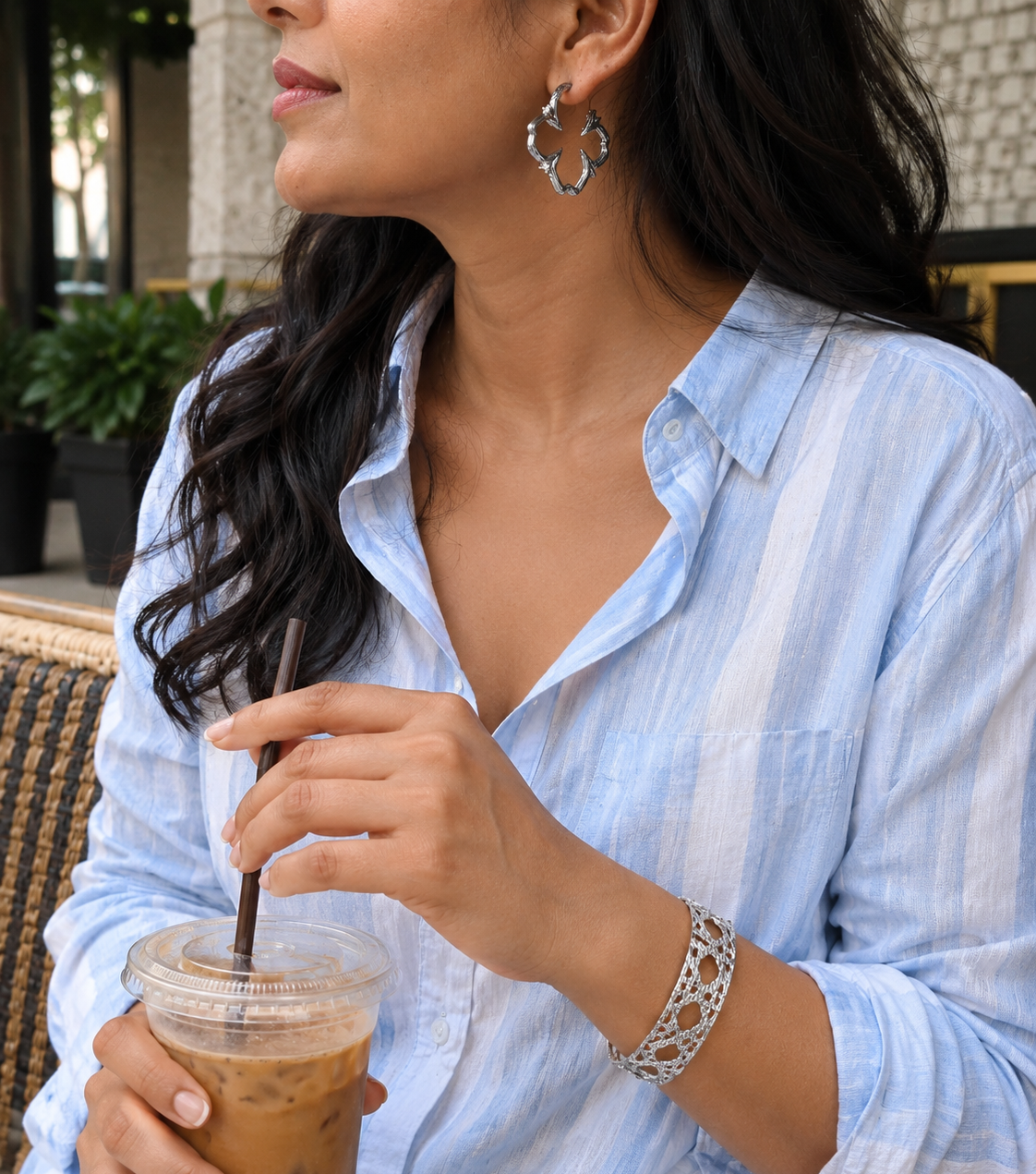 Indian Woman in a casual coffee outfit holding wearing pretty silver jewellery 